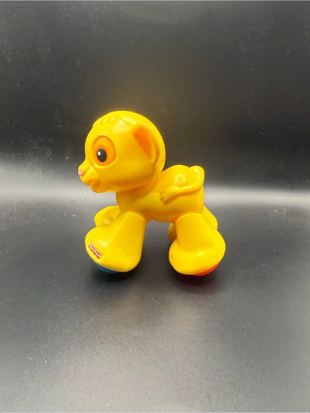 Fisher-Price Bright Yellow Lion Push Toy with Blue Wheels